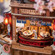 Macro of the rotating sushi counter with cat chef cutouts and a lit red lantern