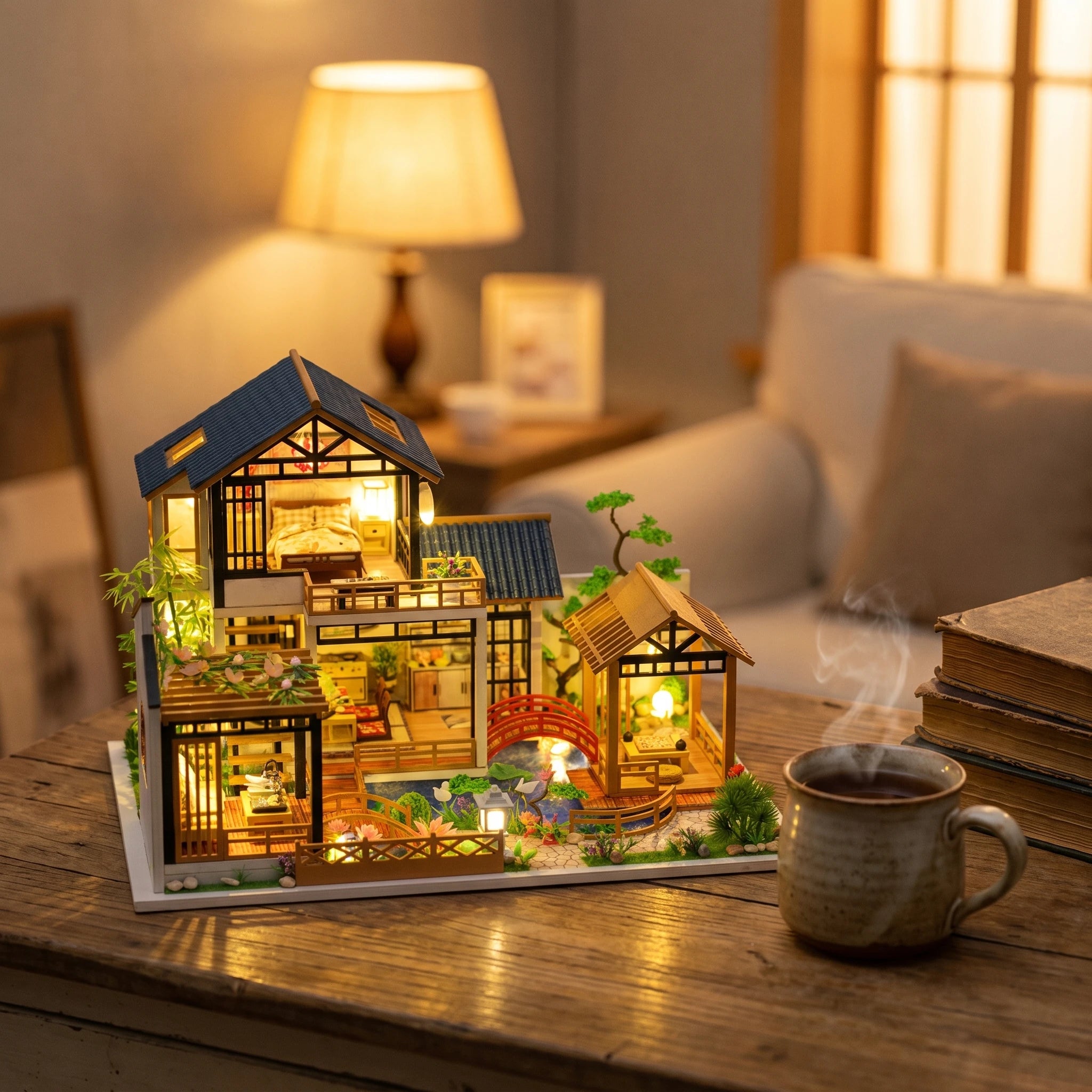The Swan Garden on a desk at dusk beside a mug of tea