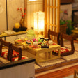 Macro of the low dining table set with dinner and red cushions