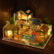 The Swan Garden glowing on a walnut shelf at night