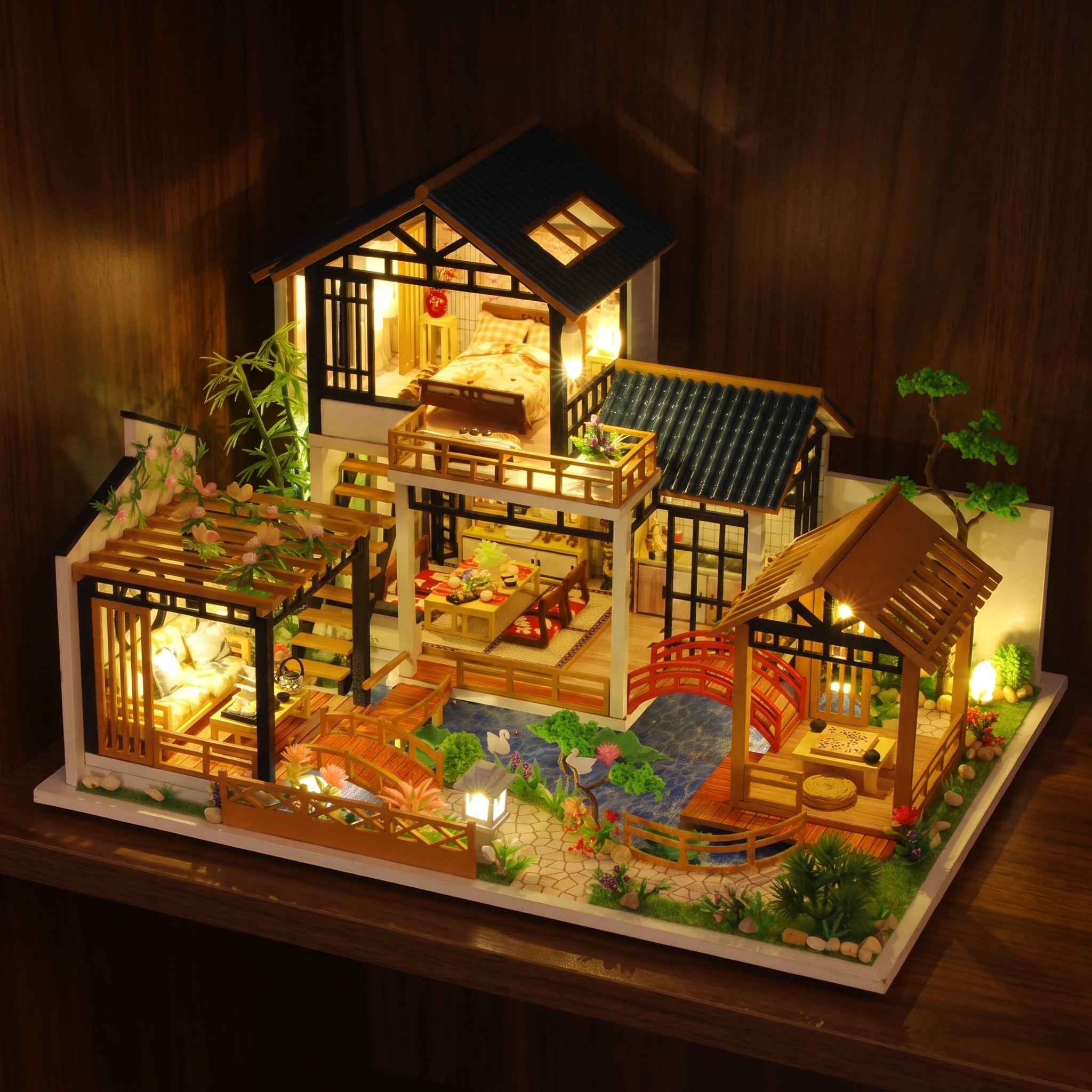 The Swan Garden glowing on a walnut shelf at night