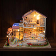 The Sweetheart Villa glowing on a dark walnut shelf at night