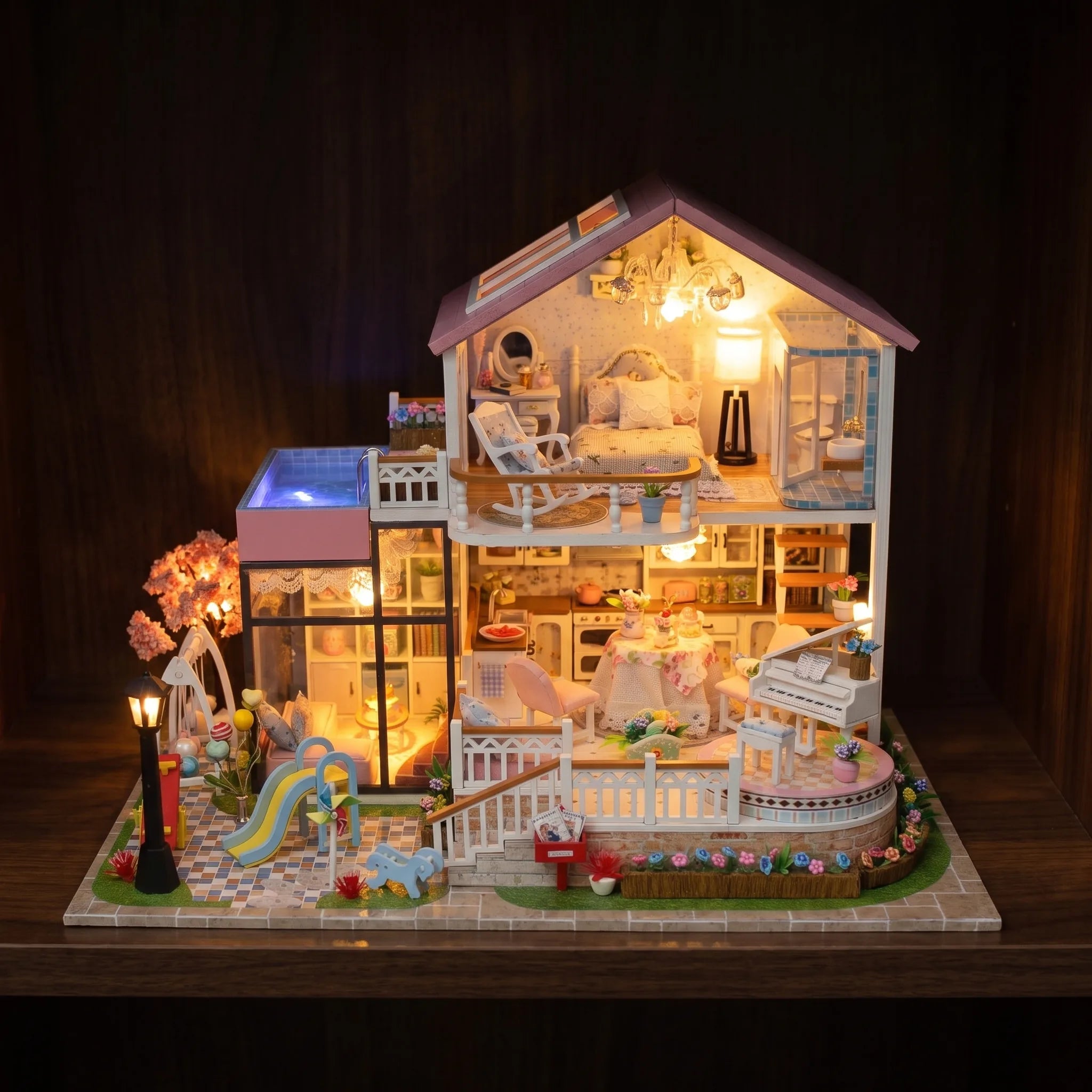 The Sweetheart Villa glowing on a dark walnut shelf at night