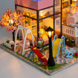 Detail of the garden playground with lit cherry blossom tree