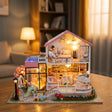 The Sweetheart Villa lit up on a wooden table in a cozy living room