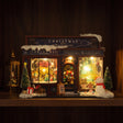 The Tinsel Emporium glowing on a walnut shelf at night