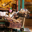 Detail of the luggage cart stacked with suitcases and wand boxes outside The Wandmaker's Atelier