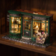 The Wandmaker's Atelier glowing on a dark walnut shelf at night
