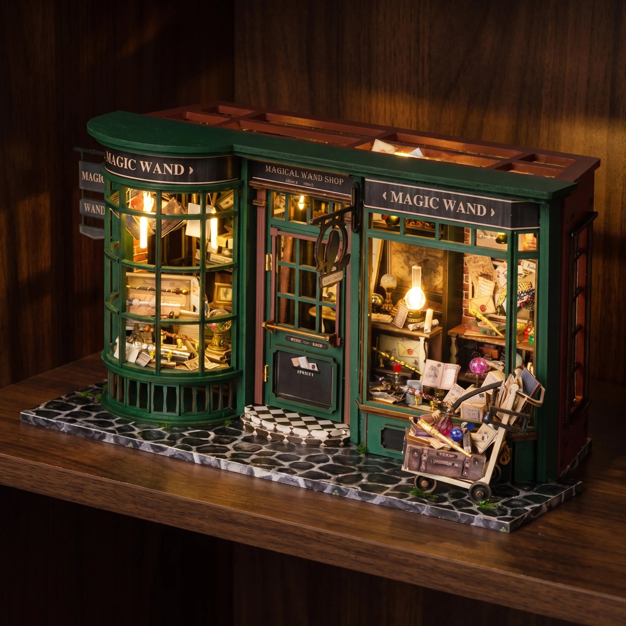 The Wandmaker's Atelier glowing on a dark walnut shelf at night