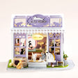 The Whisker Shop DIY miniature lavender cat shop kit with LED lights on, front view