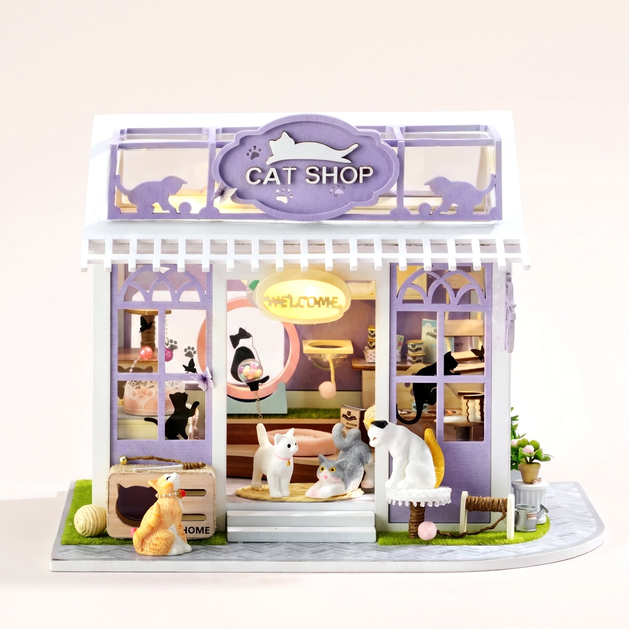 The Whisker Shop DIY miniature lavender cat shop kit with LED lights on, front view