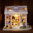 The Whisker Shop glowing on a dark walnut shelf at night