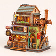The Windmill Pub miniature corner tavern kit, lamps on, on a pale blush background
