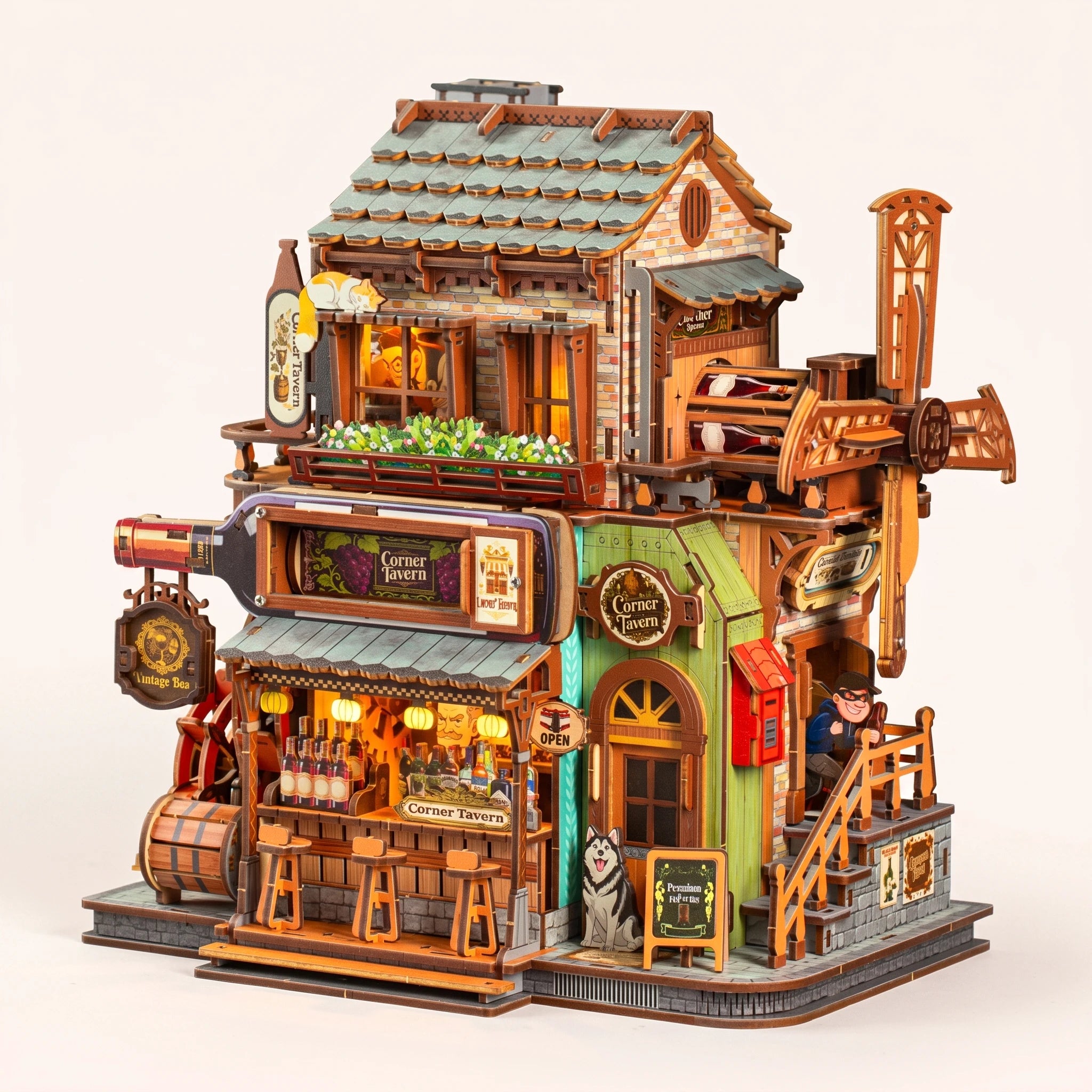 The Windmill Pub miniature corner tavern kit, lamps on, on a pale blush background