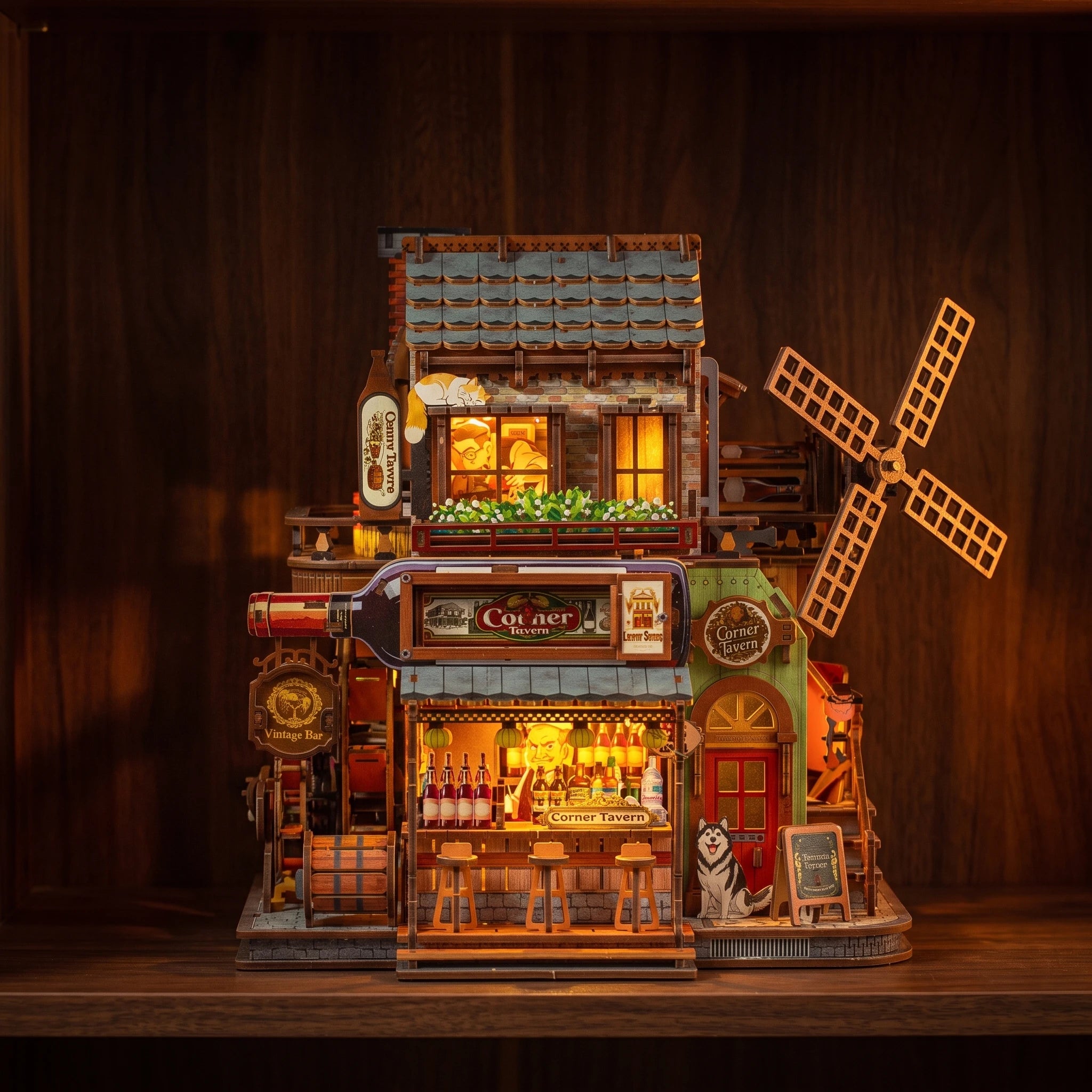 The Windmill Pub glowing at night on a dark walnut shelf