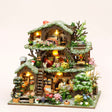 The Winterwood Treehouse DIY miniature kit with LED lights on, studio hero shot