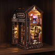 The Witch's Brew book nook glowing on a dark walnut shelf at night
