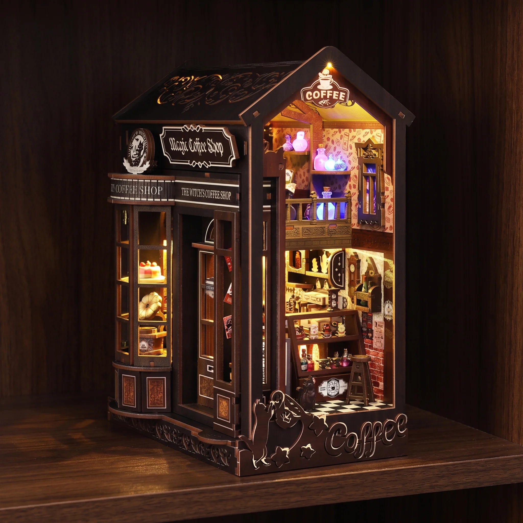 The Witch's Brew book nook glowing on a dark walnut shelf at night