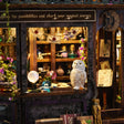 Detail of the crystal ball shop counter with the white owl and potion shelves