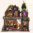 The Witch's Lair DIY miniature gothic mansion kit with LED lights on, blush studio hero
