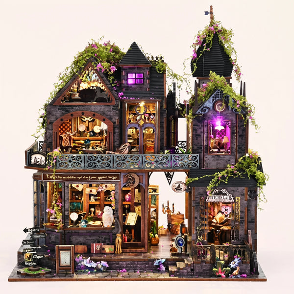 The Witch's Lair DIY miniature gothic mansion kit glowing amber and violet on a blush background