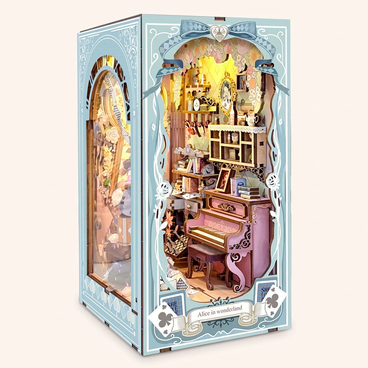 The Wonderland Keyhole DIY book nook kit, LED lights on, three-quarter view