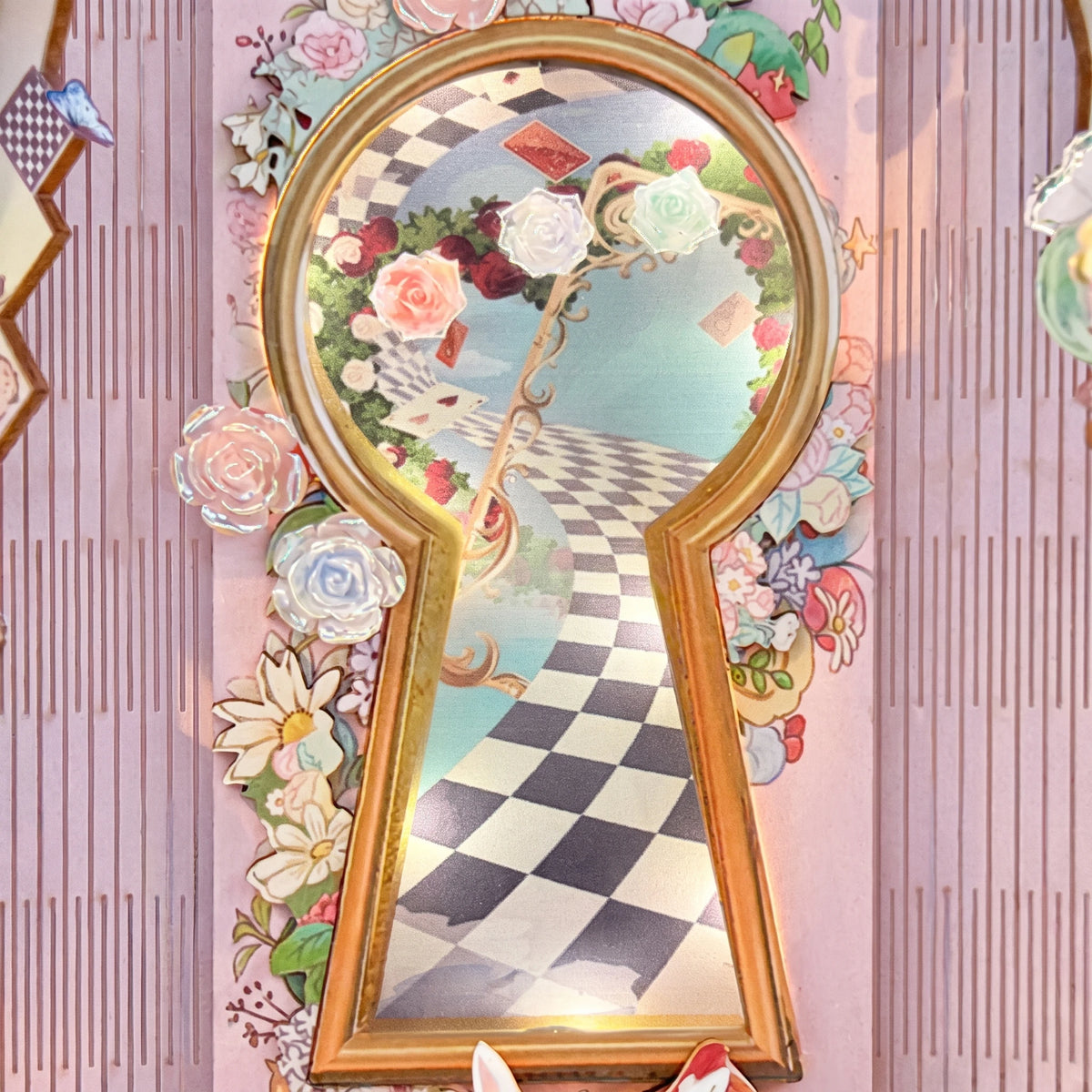 Macro of the gold keyhole and printed checkerboard path framed by paper roses
