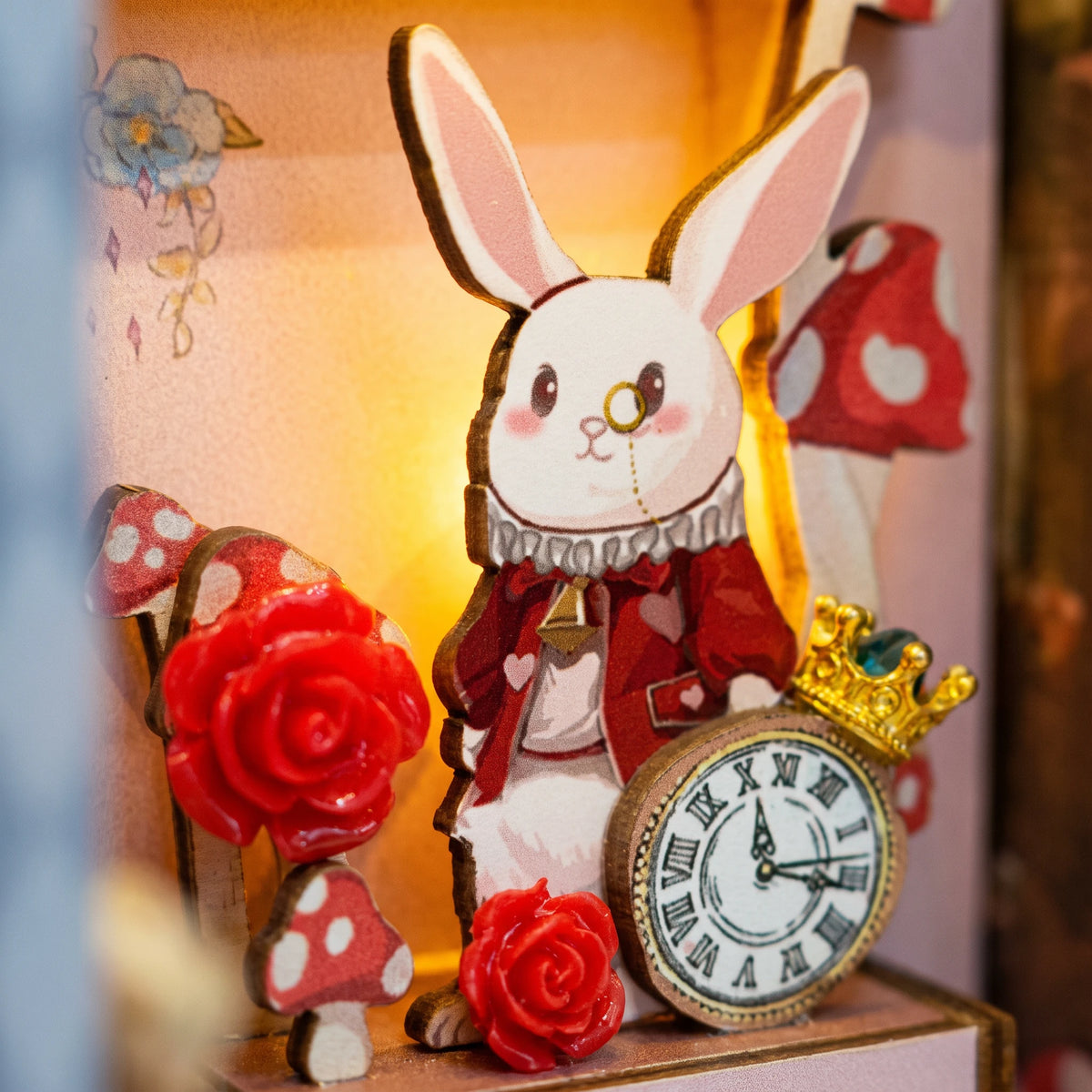 Macro of the White Rabbit cutout with his pocket watch, red roses and spotted mushrooms