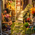 Lower garden detail: mossy stone path, tulip beds and flower stalls