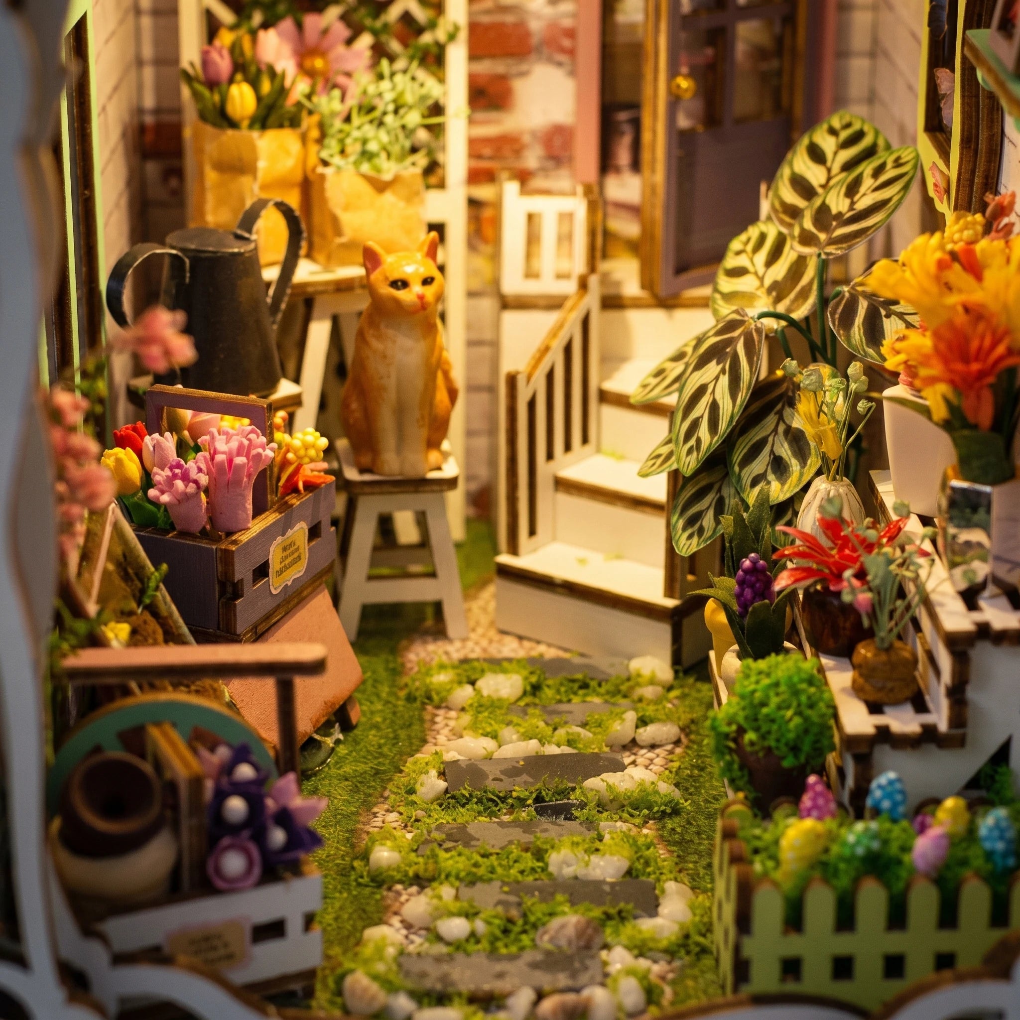 Lower garden detail: mossy stone path, tulip beds and flower stalls