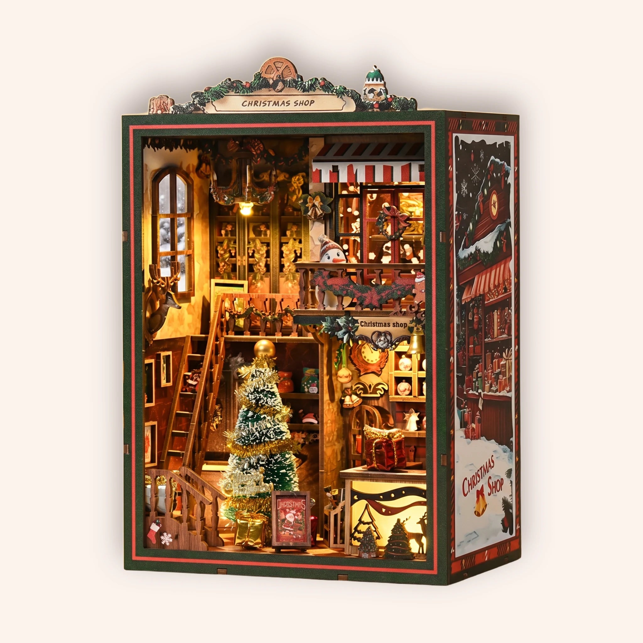 The Christmas Shop DIY book nook kit on a cream background, festive shop interior glowing